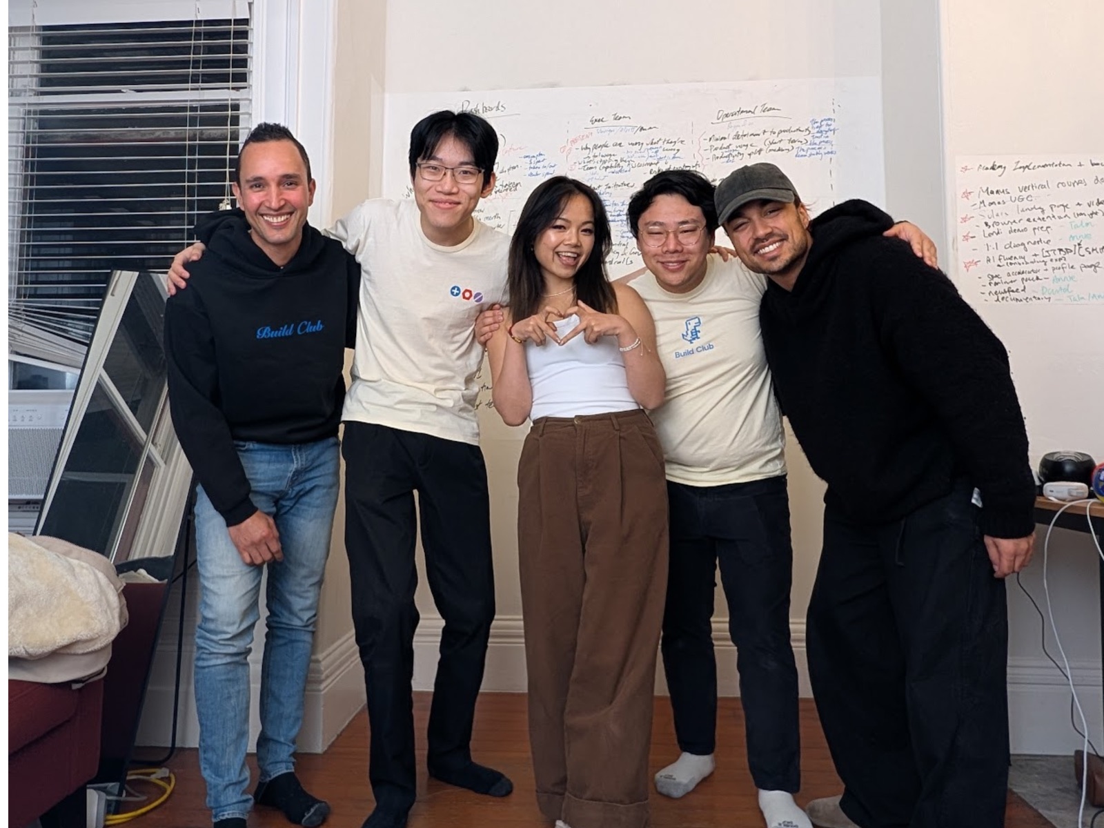 Build Club team in front of a whiteboard